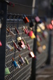 Love locks hanging on a bridge railing