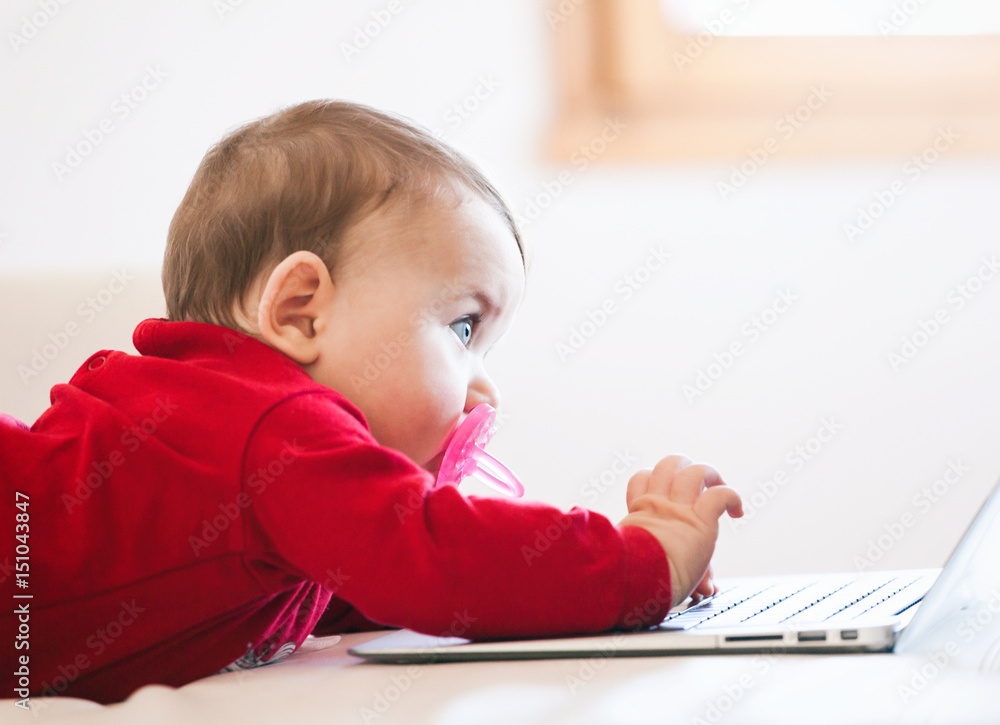 Baby girl using a laptop Baby girl using a laptop