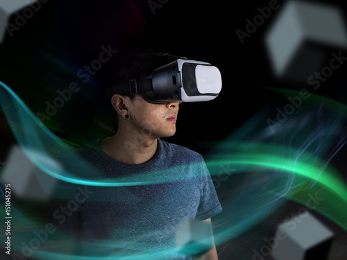 Visual reality concept.Young Asian man using Visual reality or VR headset man getting experience using VR-headset glasses. © Sataporn