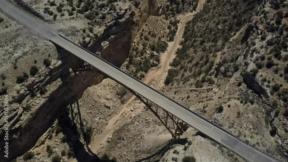 Aerial highway Eagle Canyon Bridge Utah overhead circle. Double span interstate I-70 highway crosses deep gorge. Travel traffic overhead drone view. San Rafael Reef. Wilderness desert environment.