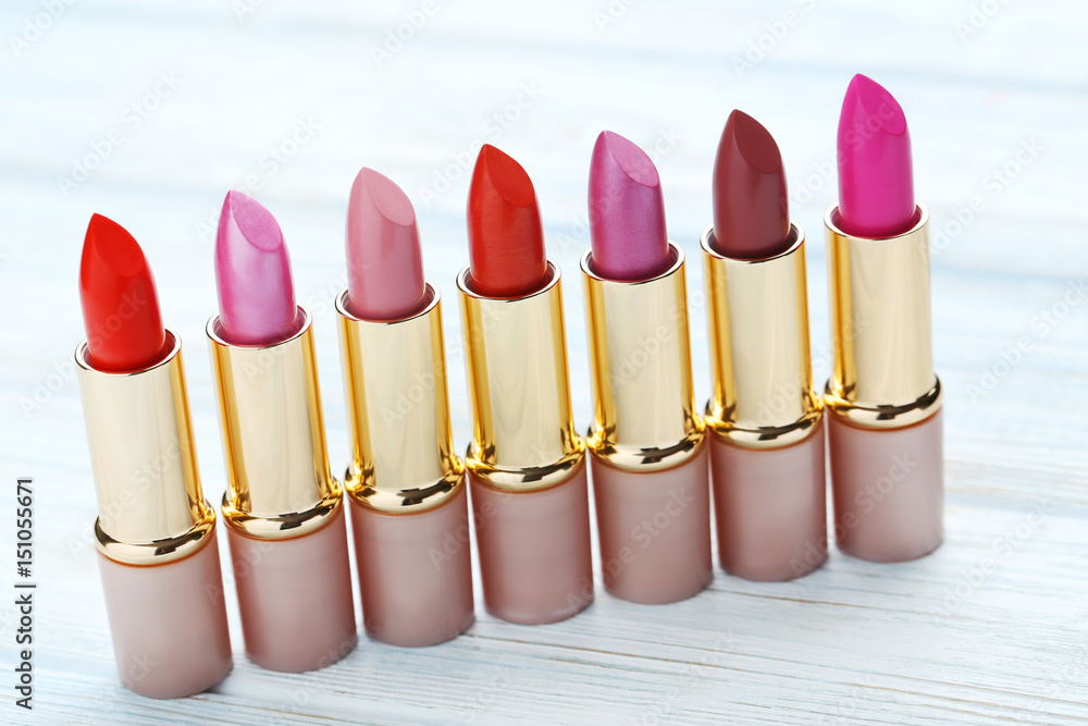 Colorful lipsticks on blue wooden table Colorful lipsticks on blue wooden table