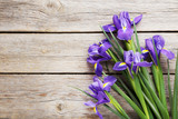 Bouquet of iris flowers on grey wooden table