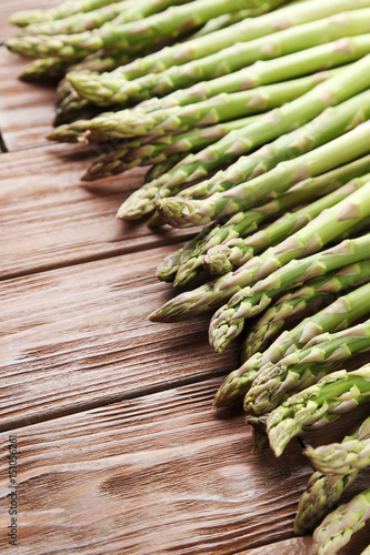 Green asparagus on brown wooden table