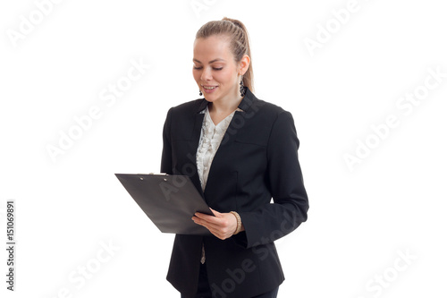 charming young business Lady in black suit looks at Tablet
