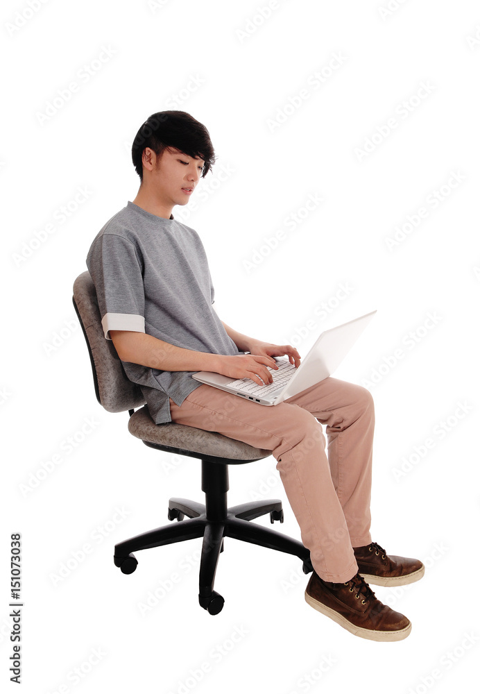 Asian man typing at his laptop. Asian man typing at his laptop.