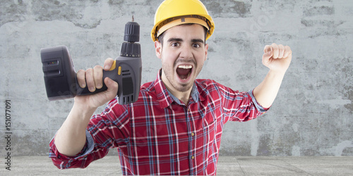 Foto worker with drill screaming euphoric