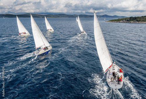Fleet of sailing boats during offshore race from bird view