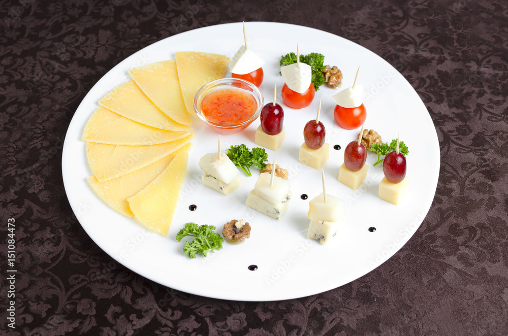 Assorted of different cheeses on a white plate