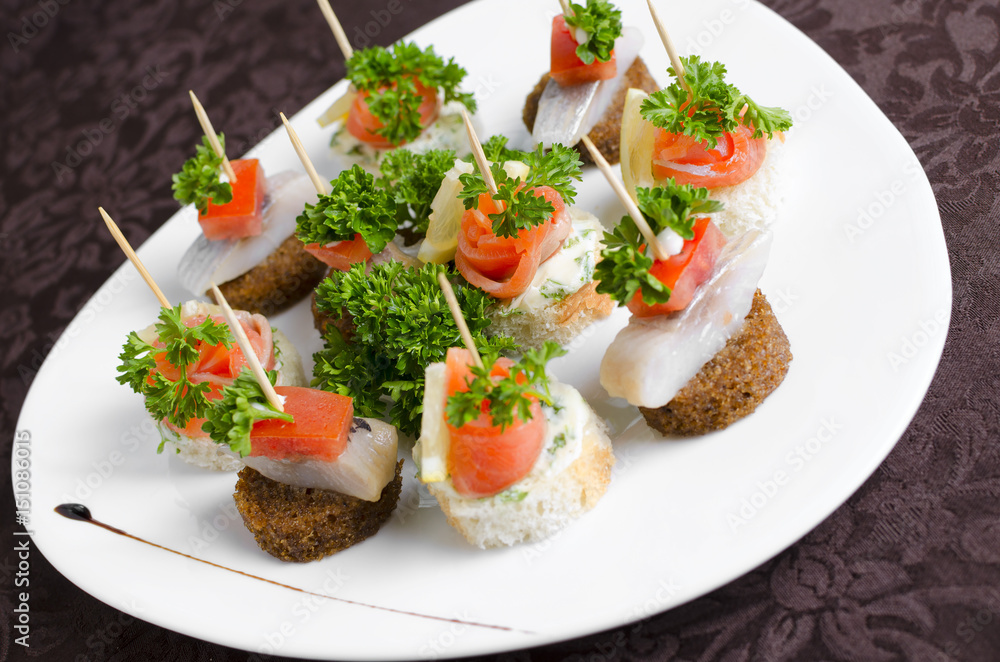Fish canapes on a white plate