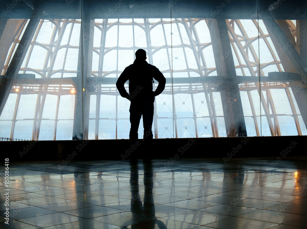 Silhouette of man standing over window Silhouette of man standing over window