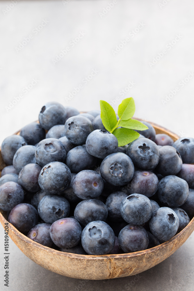 Fresh blueberries natural coconut in a bowl on a gray background. Fresh blueberries natural coconut in a bowl on a gray background.