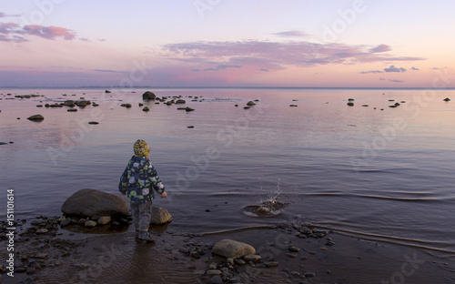 Little boy on the shore of the bay