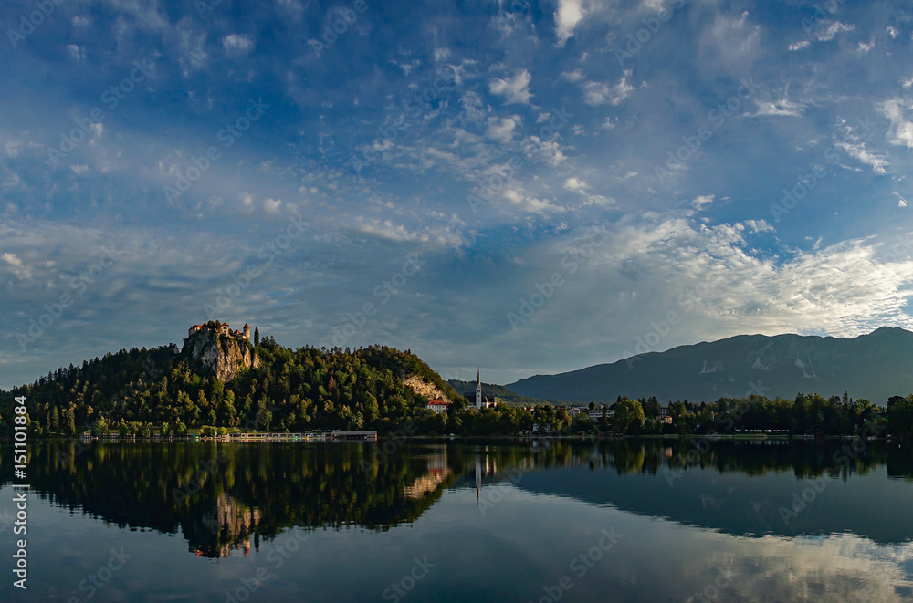Bled castle at sunrise with mountain