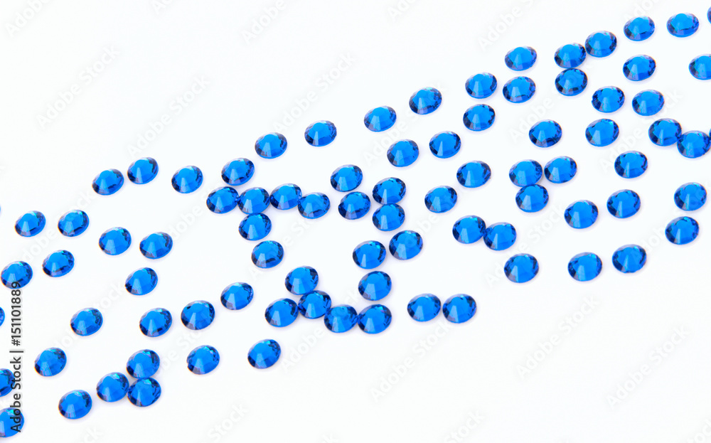 Precious sparkling rhinestones Capri blue colors on a white background.