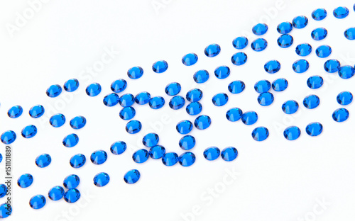 Precious sparkling rhinestones Capri blue colors on a white background.