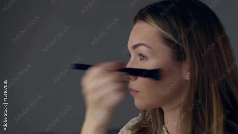 Gorgeous woman self applying smoky make-up. Girl in dress prepearing for evening celebration party. Perfect make up. Cosmetic Gorgeous woman self applying smoky make-up. Girl in dress prepearing for evening celebration party. Perfect make up. Cosmetic
