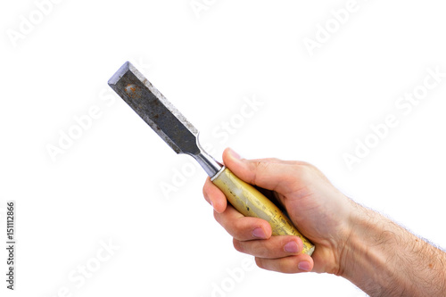 Fotografie man's hand hold old carpenter's chisel with plastic handle isolated on white bac