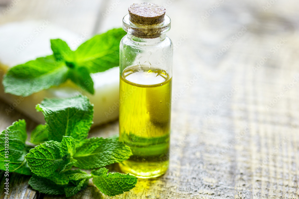 organic oil in bottle with soap and mint on light table background organic oil in bottle with soap and mint on light table background