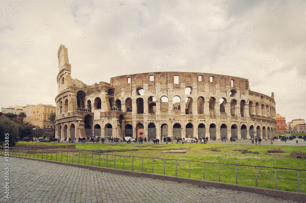 Magnificent view of the Great Roman Colosseum ( Coliseum, Colosseo ),also known as the Flavian Amphitheatre. Famous world landmark. Scenic urban landscape. Rome. Italy. Europe