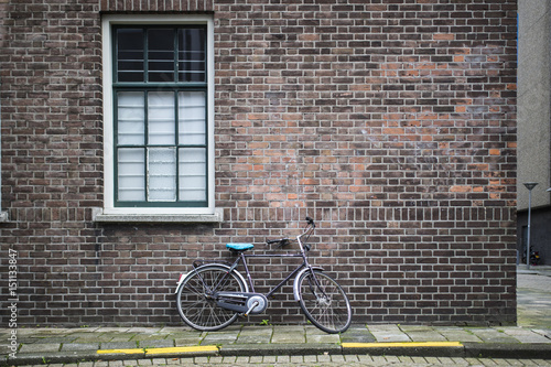 18 March 2016. Amsterdam. Netherlands. A bicycle is leaning on a wall in Amsterdam.