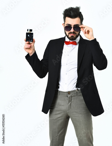 Bearded man, caucasian hipster with moustache, sunglasses and perfume bottle