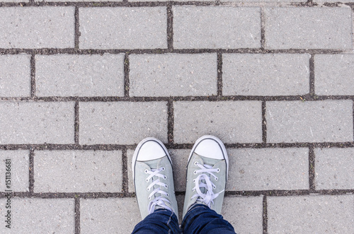 Background, legs on a background texture of a brick wall, white color on the whole frame. Horizontal frame