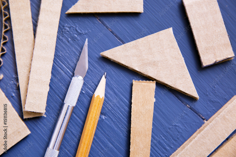 Knife, pencil and cardboard
Knife, pencil and cardboard