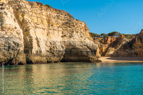 Scenic golden cliffs near Alvor, Portimao. This beach is a part of famous tourist region Algarve © anammarques