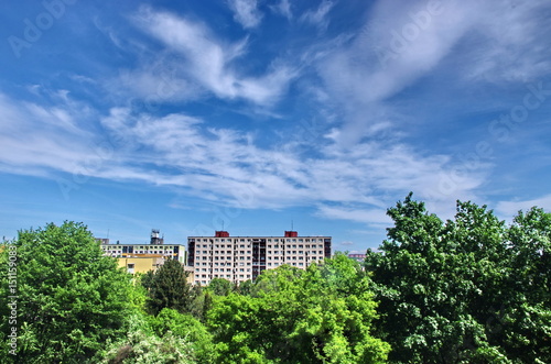 Block of Flats and trees with clouds over city. Urban building.