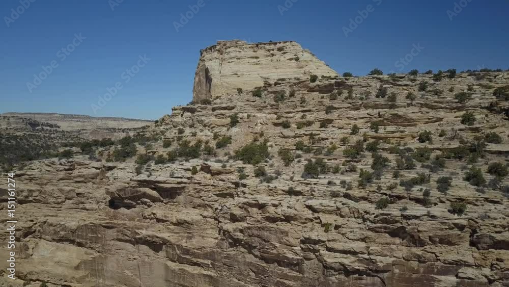 Aerial San Rafael Swell Utah dramatic cliff desert landscape. Geologic desert landscape. Erosion rock towers, cliffs, and deep canyons. 4x4 all terrain off road vehicle. Dangerous wilderness. Aerial San Rafael Swell Utah dramatic cliff desert landscape. Geologic desert landscape. Erosion rock towers, cliffs, and deep canyons. 4x4 all terrain off road vehicle. Dangerous wilderness.