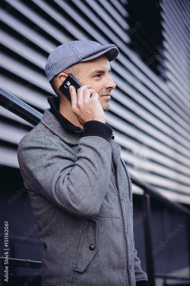 Handsome man talking on mobile phone outdoors Handsome man talking on mobile phone outdoors