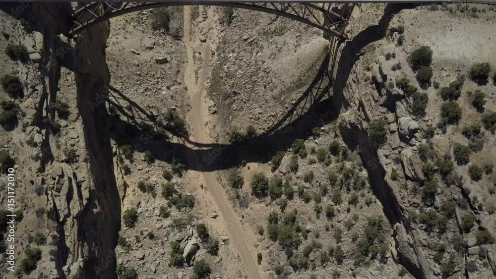 Aerial Eagle Canyon Bridge highway utah overhead. Double span interstate I-70 highway crosses deep gorge. Travel traffic overhead drone. San Rafael geologic desert landscape. Dangerous wilderness.