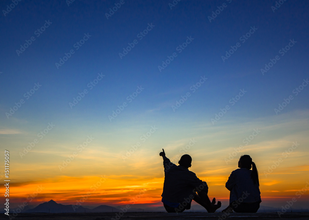 Silhouette of couple love outside sunset