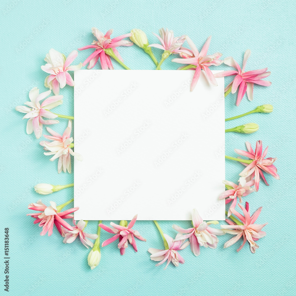 bunch of little lovely flower on white empty paper card over blue background for making card in mother's day, wedding invitation, anniversary or fill word in special occasionally bunch of little lovely flower on white empty paper card over blue background for making card in mother's day, wedding invitation, anniversary or fill word in special occasionally