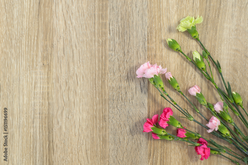 Flowers lie on a wooden surface and place for text. Flowers lie on a wooden surface and place for text.