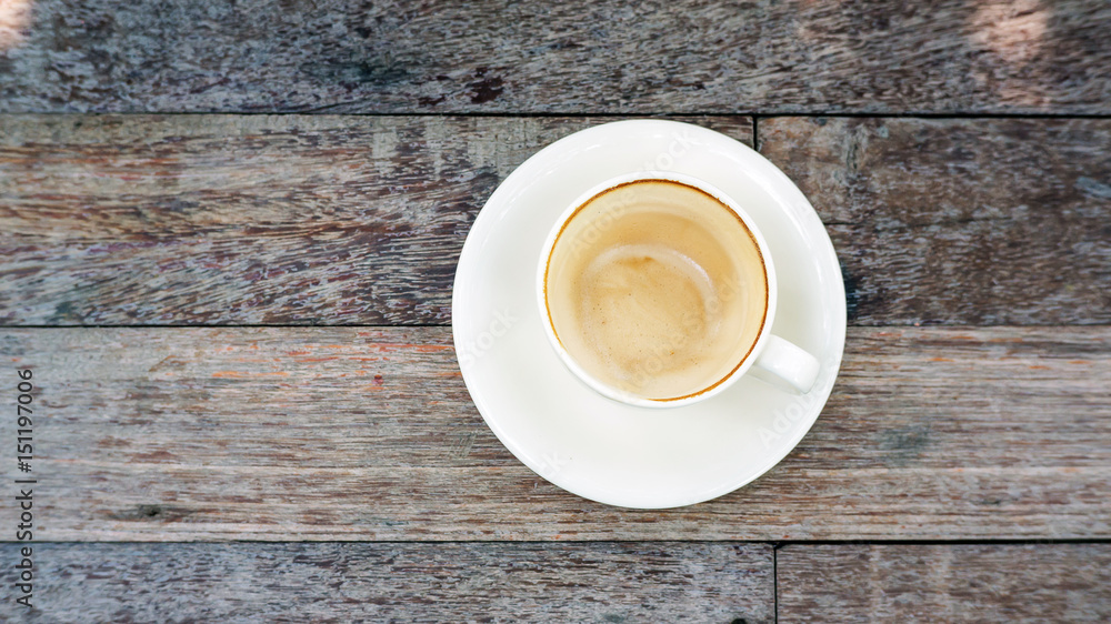 empty coffee cup after drink on a wooden table. empty coffee cup after drink on a wooden table.