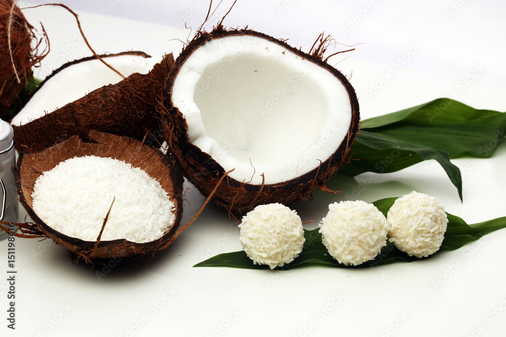 Tasty candies in coconut flakes on plate Tasty candies in coconut flakes on plate