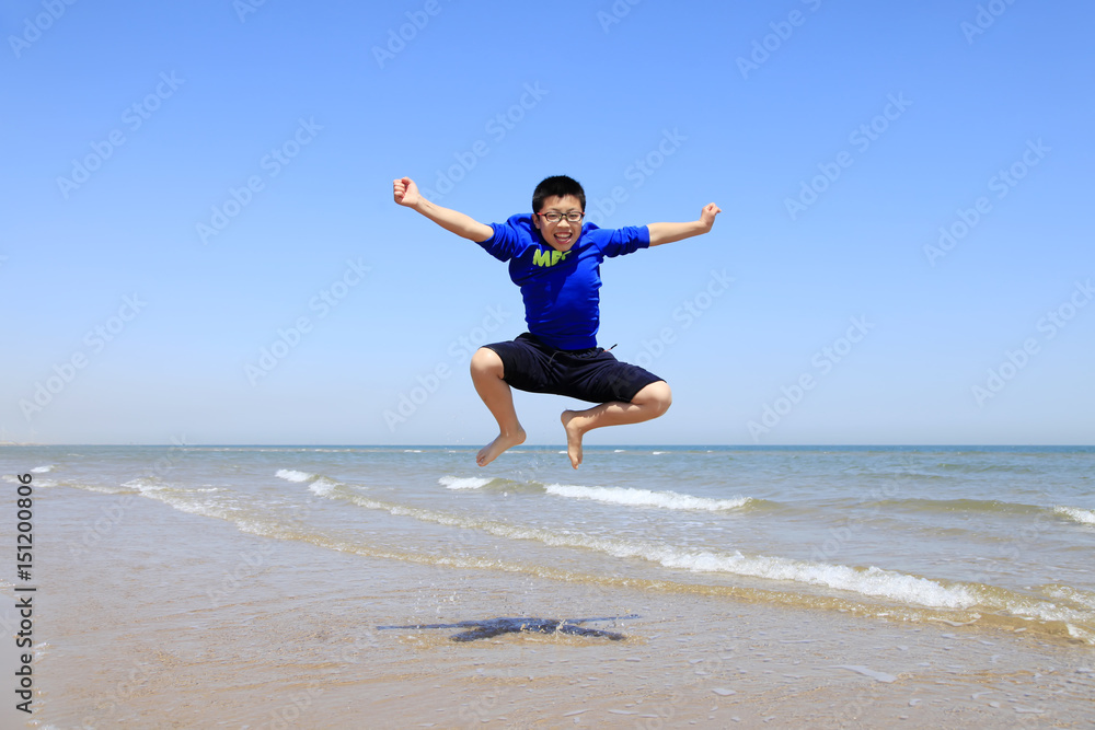 A boy playing on the beach