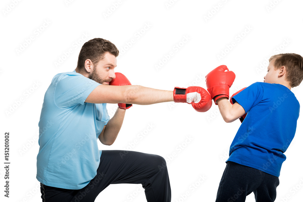 Happy father with son during boxing training isolated on white