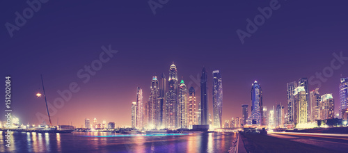Photography Fisheye lens panoramic picture of Dubai waterfront skyline at night, color toning applied, United Arab Emirates