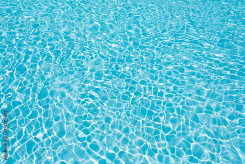 Abstract water surface in swimming pool, Beautiful blue water in pool with sun reflection