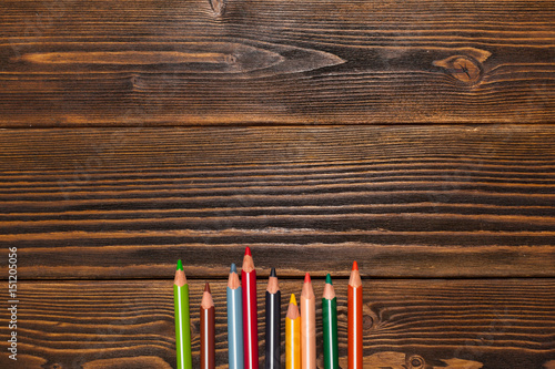 Drawing colourful pencils on brown wooden table
