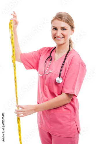 Lady nutritionist measuring with yellow tape photo