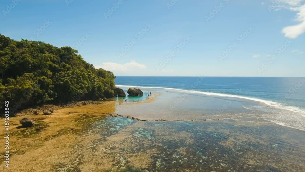 Tropical beach with natural rock pools in the Siargao Island. Aerial view Magpupungko natural rock pools. 4K, Travel concept, Aerial footage. Tropical beach with natural rock pools in the Siargao Island. Aerial view Magpupungko natural rock pools. 4K, Travel concept, Aerial footage.