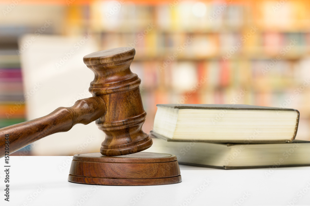 Wooden gavel and books on wooden table Wooden gavel and books on wooden table