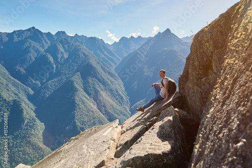 Man sit on mountain peak