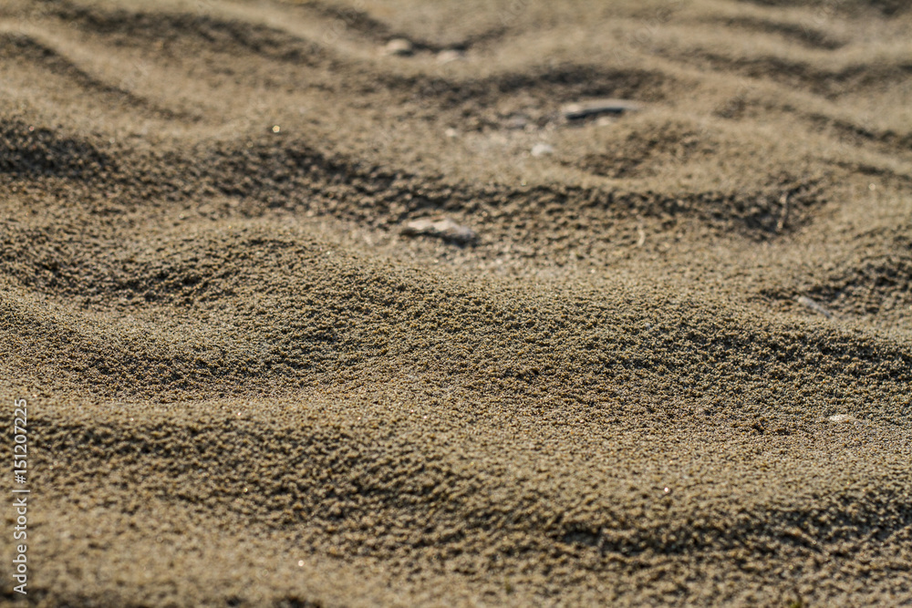 A texture of river brown sand in summer on a sunny day in the desert. A texture of river brown sand in summer on a sunny day in the desert.
