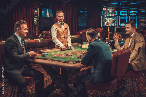 Upper class friends gambling in a casino