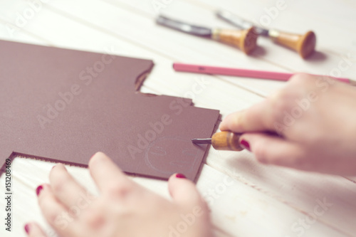 Hands draw and carve a linocut, concept handicraft