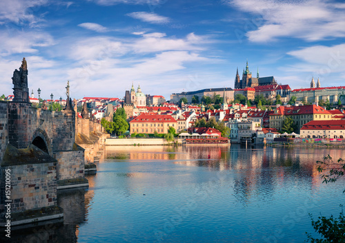 Colorful morning view of Charles Bridge, Prague Castle and St. Vitus cathedral on Vltava river
